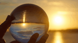 10 steps to help you build a better financial future blog- image of a crystal ball held up to a sunset