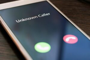 How to spot the signs of a pension scam - image shows a mobile phone with an unknown caller ringing.