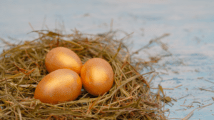 Image depicts a nest of golden eggs, against a faded blue background, symbolising taking out a tax-free lump sum from your pension nest egg.