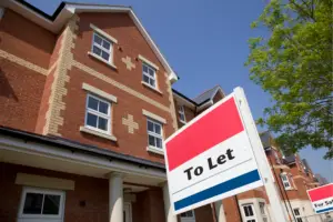 Are the tax benefits of buying a buy-to-let property worth it? Image for blog of a red brick property with a to let sign